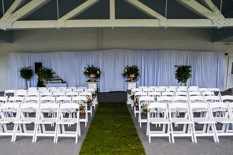 White backdrop pipe and drape for wedding ceremony