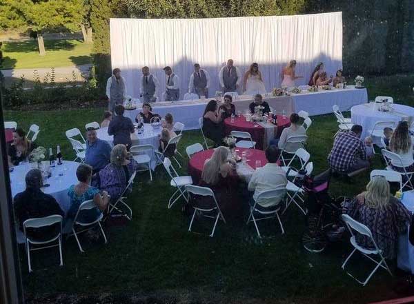 White backdrop for backyard wedding