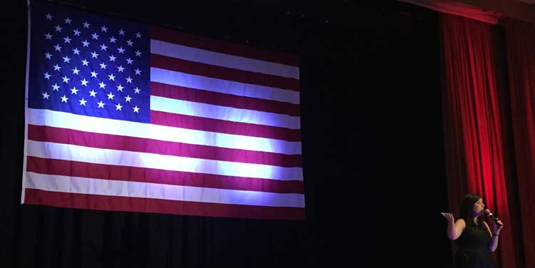 Patriotic white uplighting on flag and red uplighting on curtain | Rent online for $19/each + free shipping both ways nationwide at www.RentMyWedding.com/Rent-Uplighting