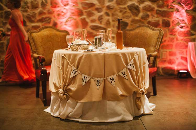 Red Uplighting Behind Sweetheart Table | Rent online for $19/each + free shipping both ways nationwide at www.RentMyWedding.com/Rent-Uplighting